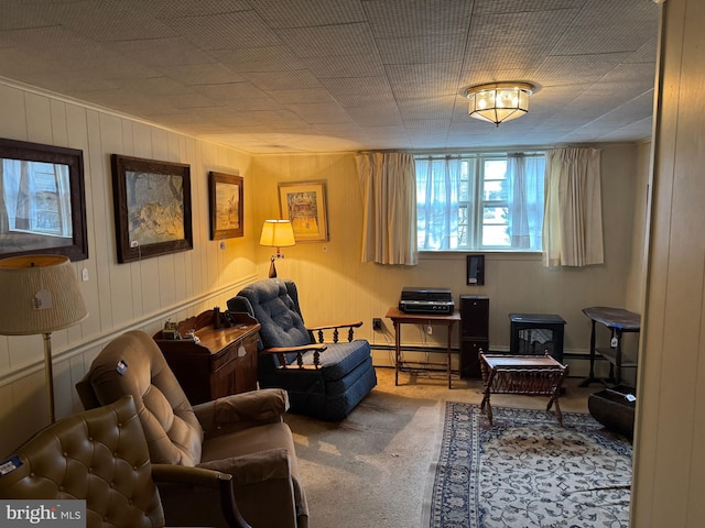 carpeted living area featuring a baseboard heating unit