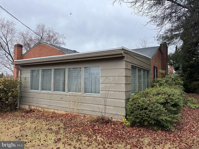 view of side of property with a chimney