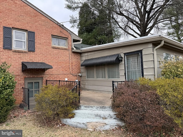 property entrance featuring brick siding