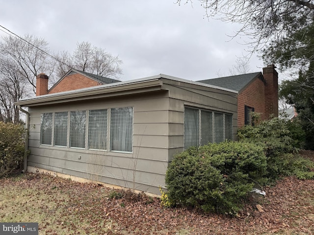 view of side of property featuring a chimney