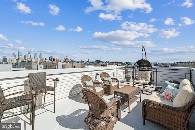 view of patio with a city view, a balcony, and an outdoor hangout area