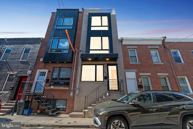 townhome / multi-family property featuring brick siding