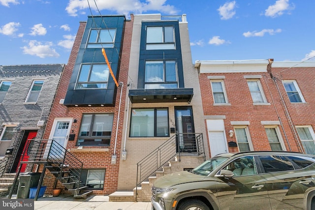 townhome / multi-family property featuring brick siding