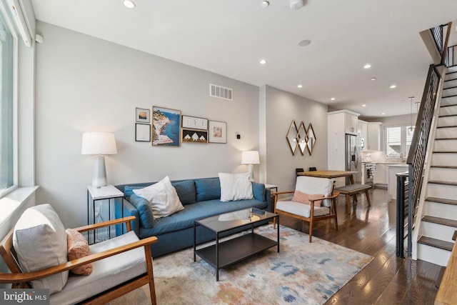 living room with visible vents, recessed lighting, stairs, and wood-type flooring