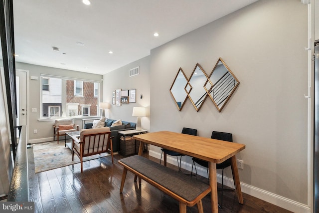 dining area with dark wood-style floors, visible vents, recessed lighting, and baseboards