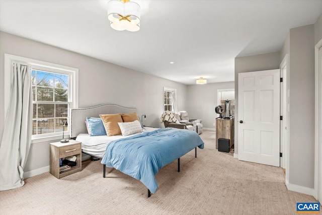 carpeted bedroom featuring baseboards