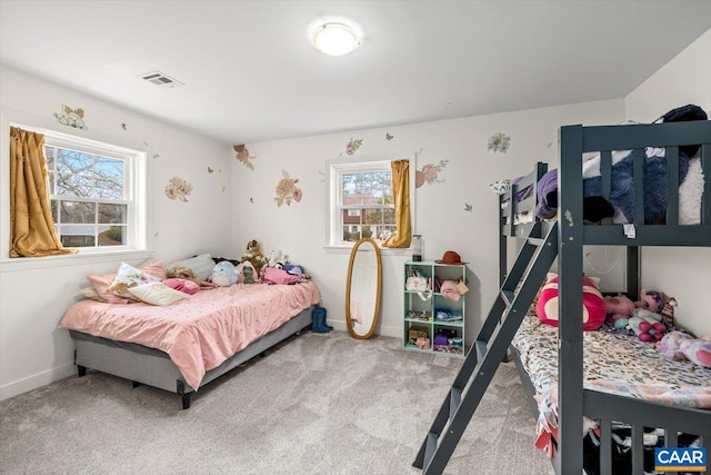 bedroom with baseboards, visible vents, and light colored carpet