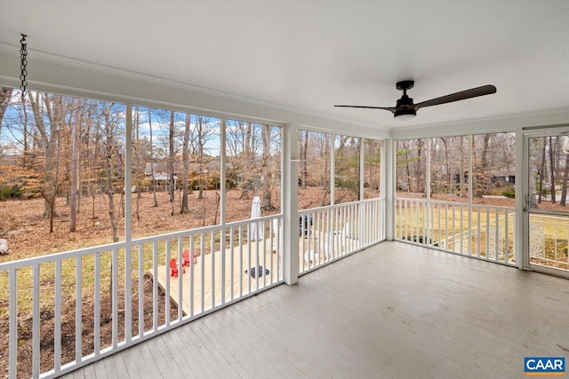 unfurnished sunroom featuring ceiling fan