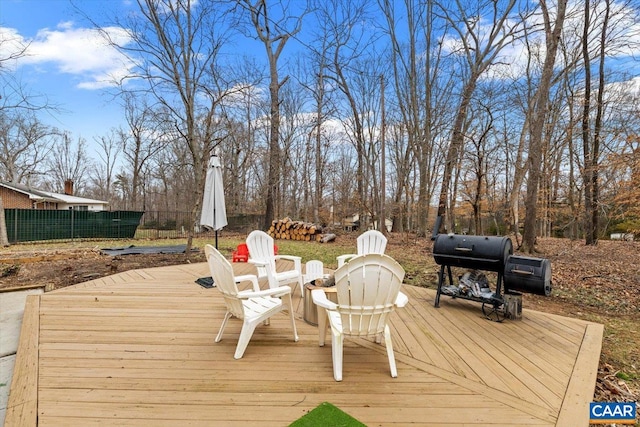 wooden terrace featuring area for grilling and fence