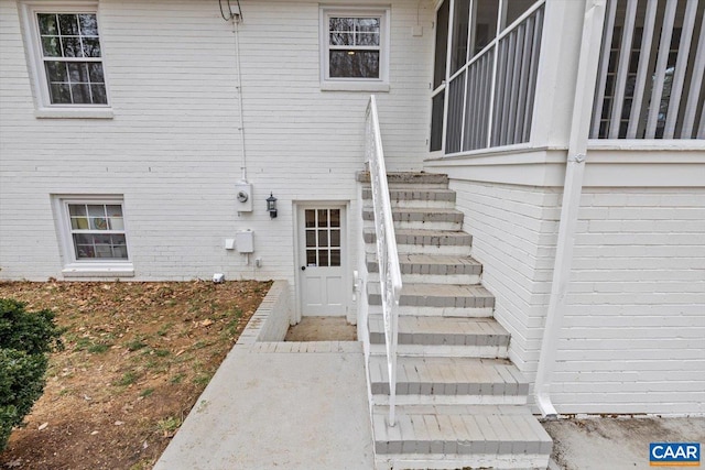 property entrance featuring brick siding