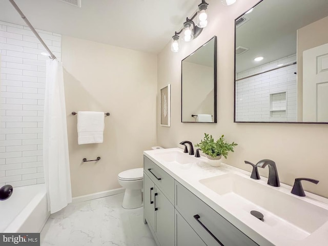 full bathroom featuring toilet, marble finish floor, baseboards, and a sink