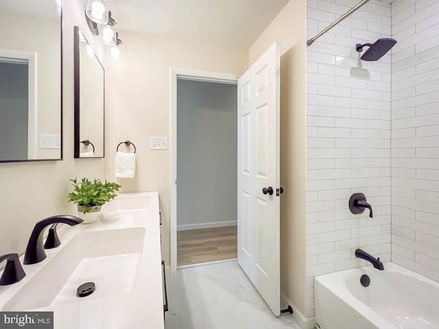 full bathroom featuring marble finish floor, double vanity, a sink, and shower / tub combination