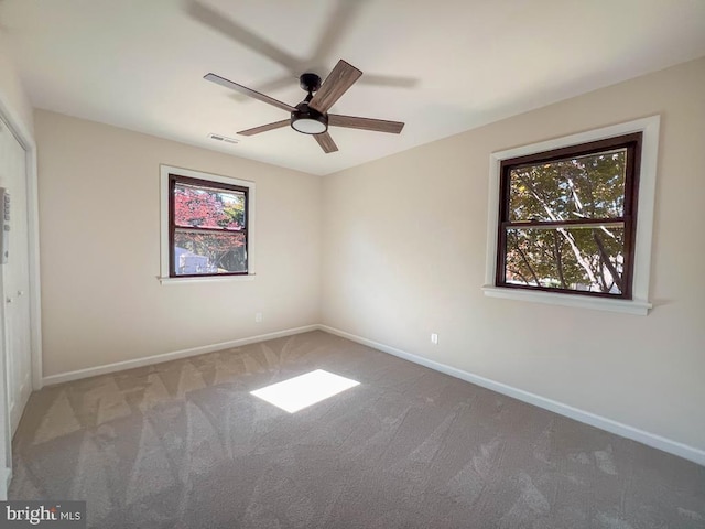 unfurnished room with carpet floors, ceiling fan, and baseboards