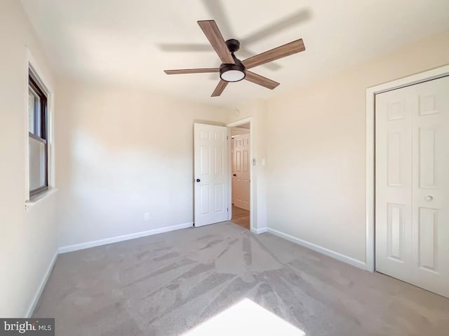 unfurnished bedroom featuring carpet, a closet, and baseboards