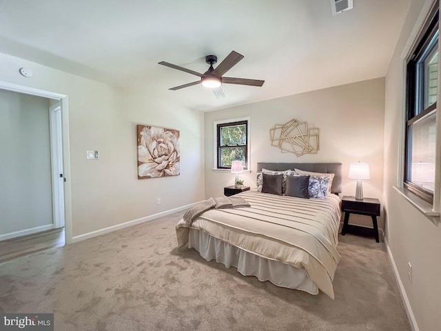 bedroom featuring carpet floors, baseboards, visible vents, and ceiling fan