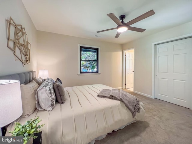 carpeted bedroom with baseboards, visible vents, and a ceiling fan