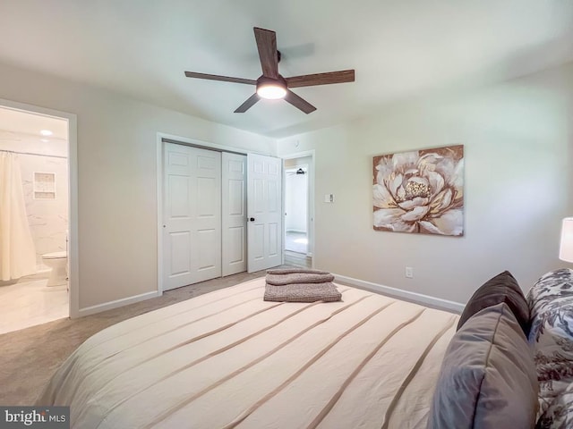 bedroom with carpet floors, baseboards, a closet, and ensuite bathroom