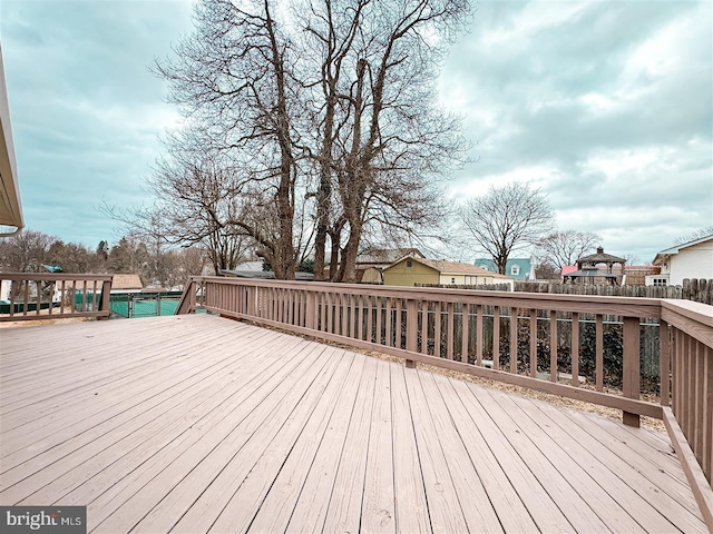 wooden terrace featuring fence