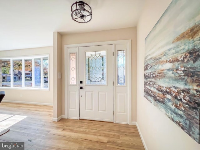 entryway featuring baseboards and light wood-style floors