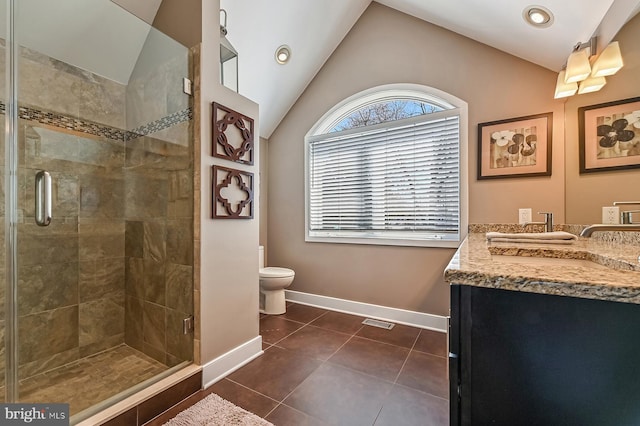 bathroom with tile patterned floors, a stall shower, baseboards, vanity, and vaulted ceiling