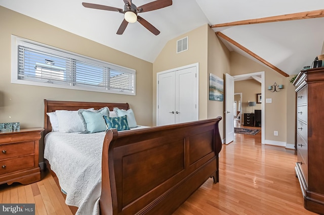 bedroom with visible vents, ceiling fan, baseboards, lofted ceiling, and light wood-style floors