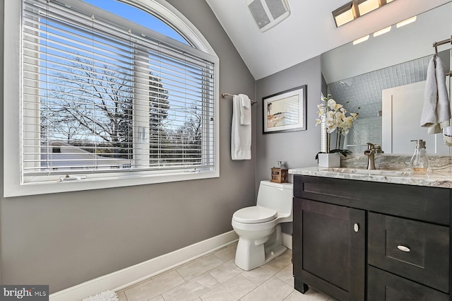 bathroom featuring visible vents, toilet, baseboards, vanity, and vaulted ceiling