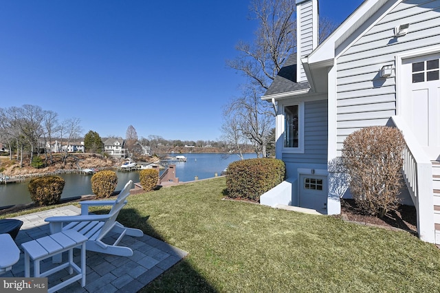 view of yard featuring a patio and a water view