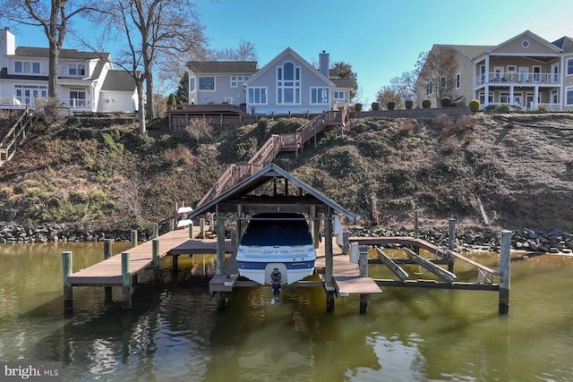 dock area with a water view and boat lift