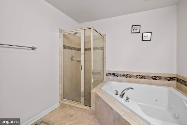 bathroom with a shower stall, a tub with jets, baseboards, and tile patterned floors