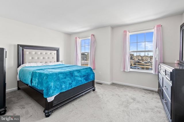 carpeted bedroom featuring visible vents and baseboards