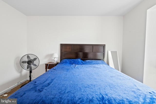 bedroom with baseboards and carpet floors