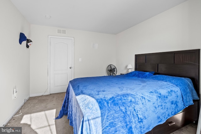 carpeted bedroom with baseboards and visible vents