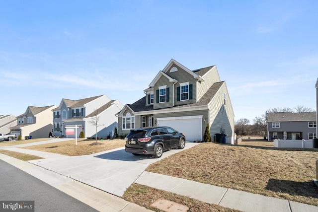 view of front of property featuring an attached garage, a residential view, and driveway