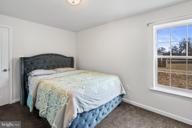 bedroom featuring baseboards and carpet