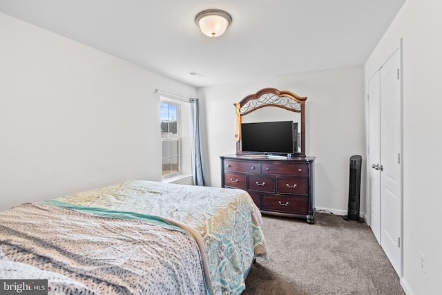 carpeted bedroom with visible vents and baseboards