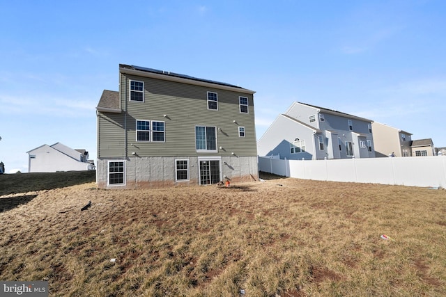 back of house featuring a yard and fence