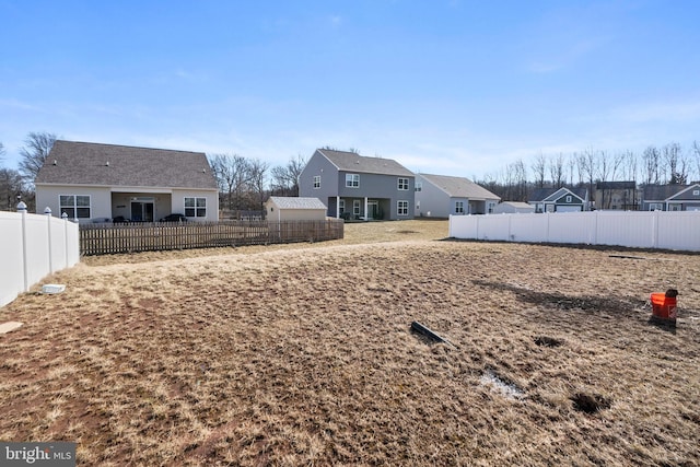 view of yard featuring a residential view and a fenced backyard