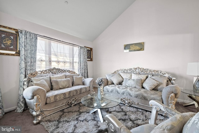 living area featuring carpet flooring, baseboards, and high vaulted ceiling