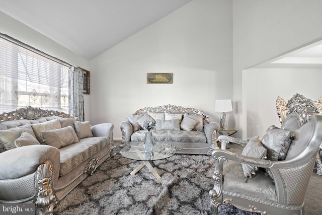 living room featuring high vaulted ceiling