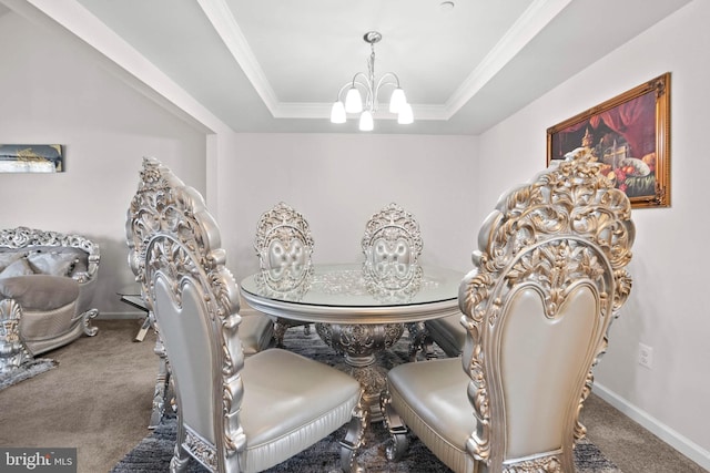 dining area featuring a chandelier, crown molding, a raised ceiling, and carpet floors