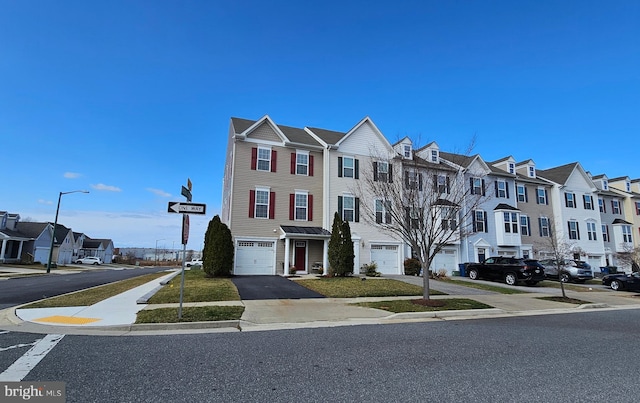 multi unit property featuring a garage and a residential view