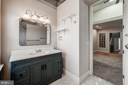 bathroom with vanity and baseboards