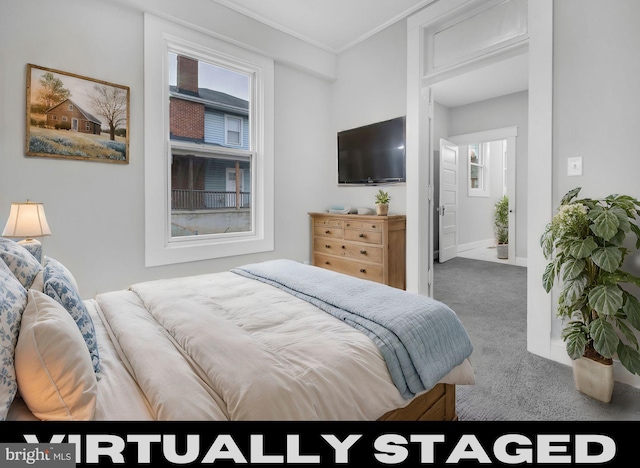 carpeted bedroom with baseboards, multiple windows, and crown molding