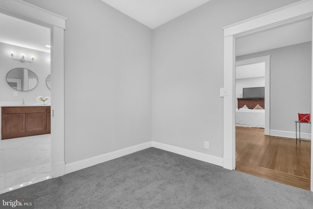 interior space featuring baseboards and a sink