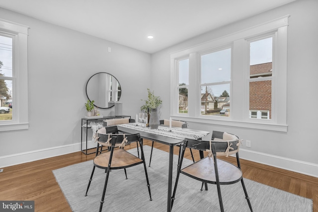 dining space with recessed lighting, wood finished floors, and baseboards