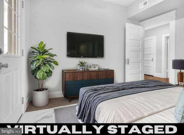 bedroom with marble finish floor, baseboards, and visible vents