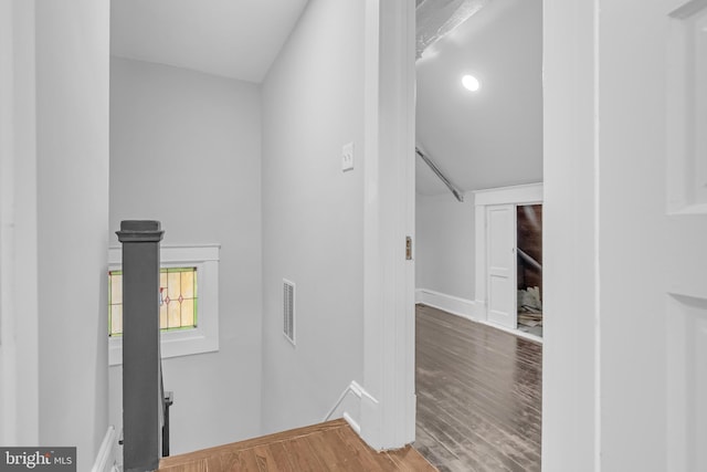 corridor with visible vents and wood finished floors