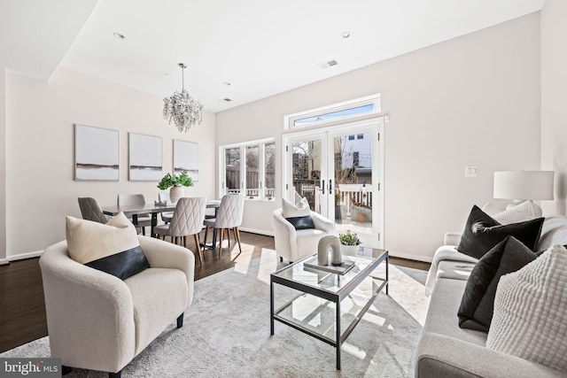 living room featuring baseboards, wood finished floors, and french doors