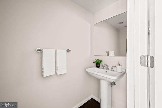 bathroom featuring a sink and baseboards