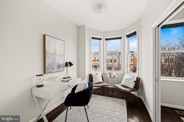 office space featuring baseboards and wood finished floors